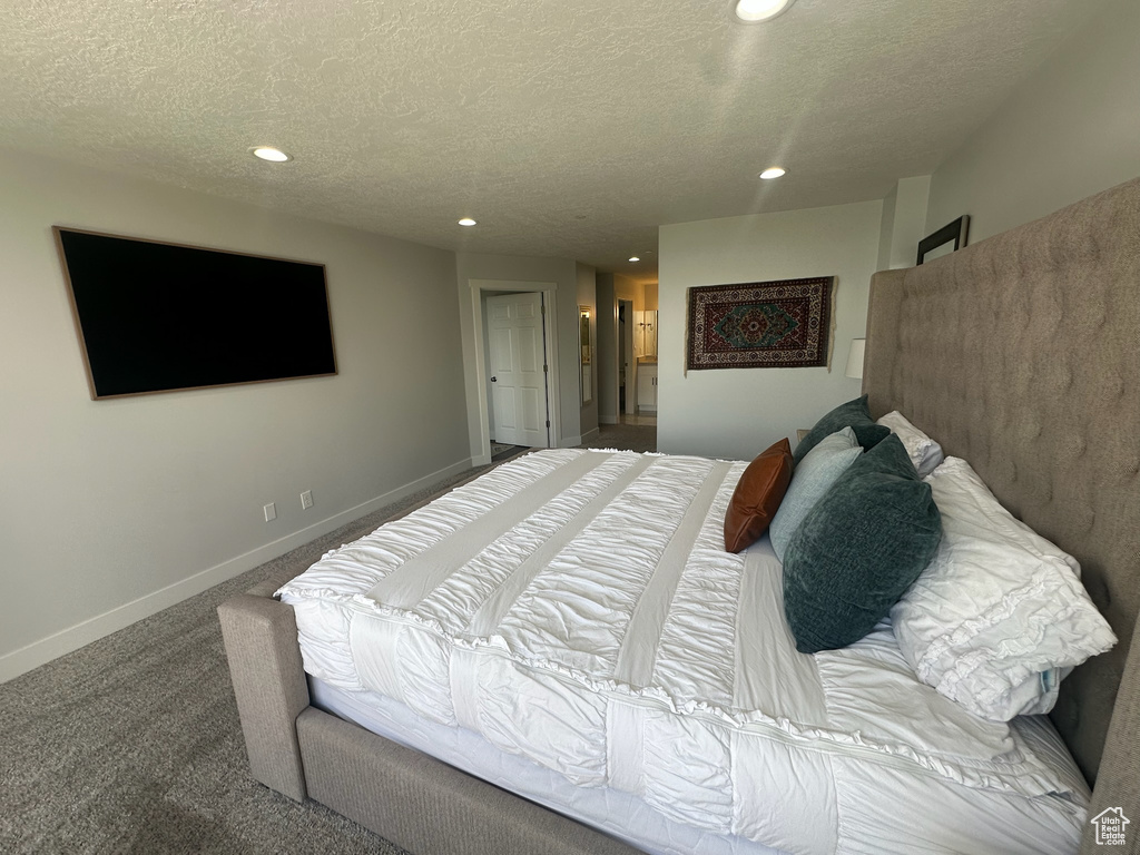 Bedroom with baseboards, carpet flooring, recessed lighting, and a textured ceiling