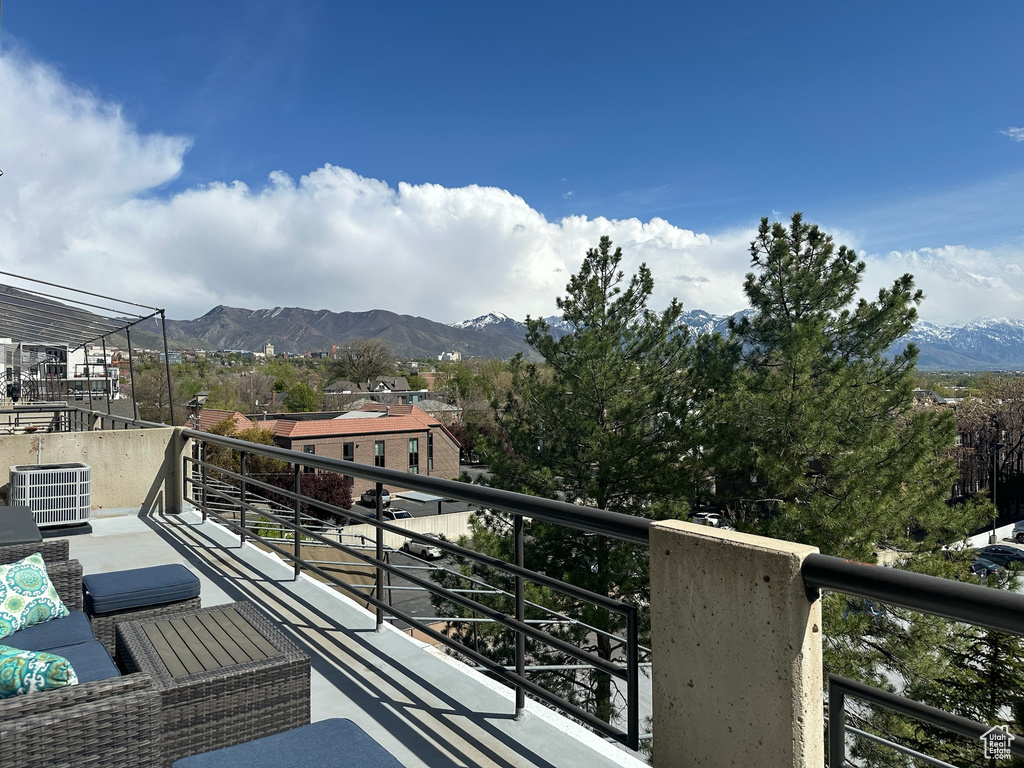 Balcony featuring central air condition unit and a mountain view