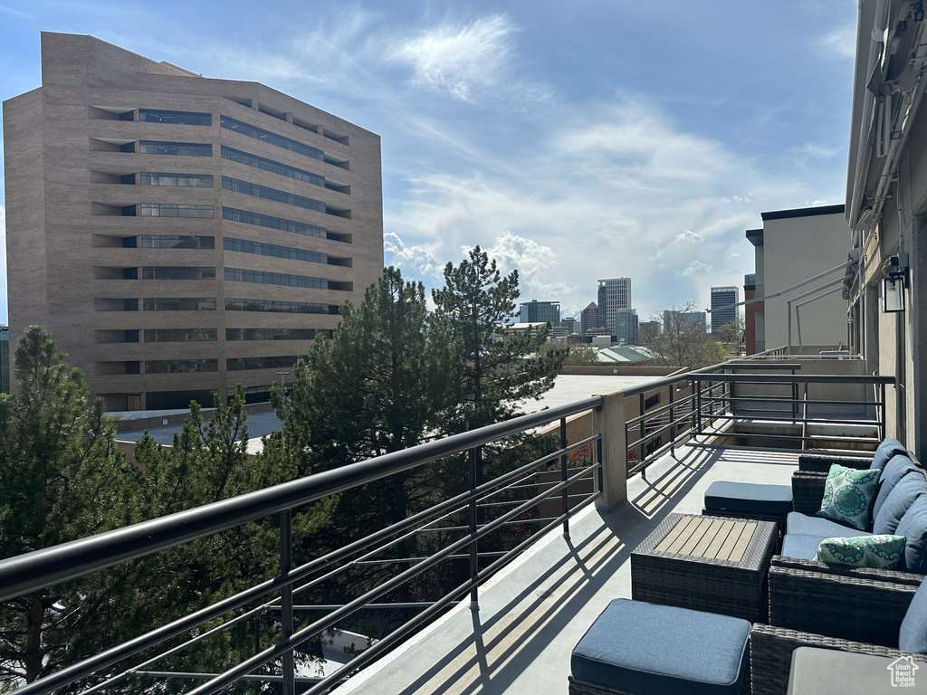 Balcony featuring an outdoor living space and a view of city