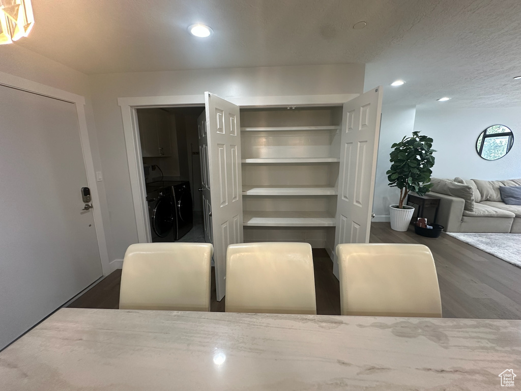 Dining space featuring separate washer and dryer, wood finished floors, and recessed lighting