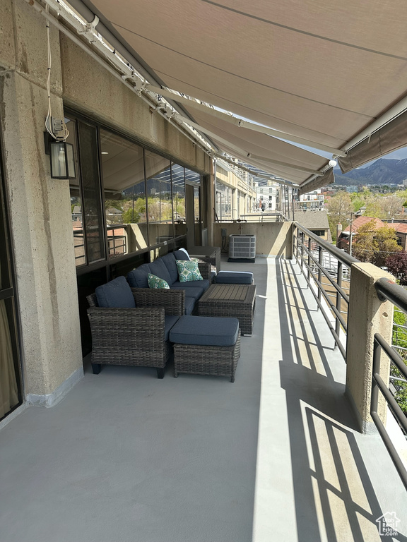 Balcony with central air condition unit and outdoor lounge area
