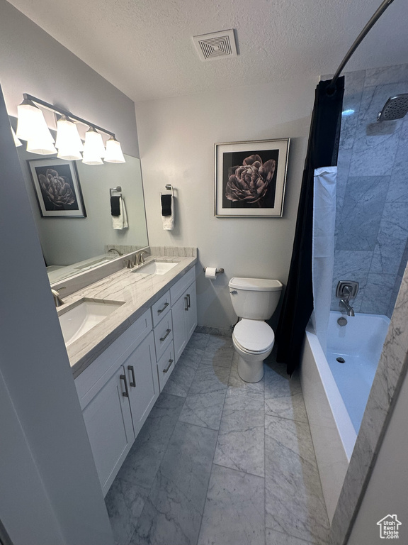 Bathroom featuring a sink, marble finish floor, double vanity, toilet, and visible vents