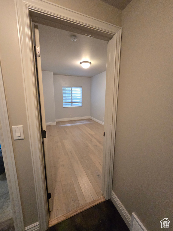 Hall with wood finished floors and baseboards