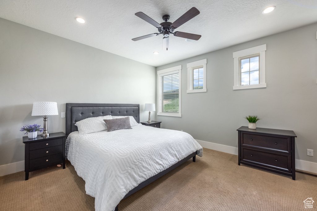 Bedroom featuring light colored carpet, recessed lighting, and a ceiling fan