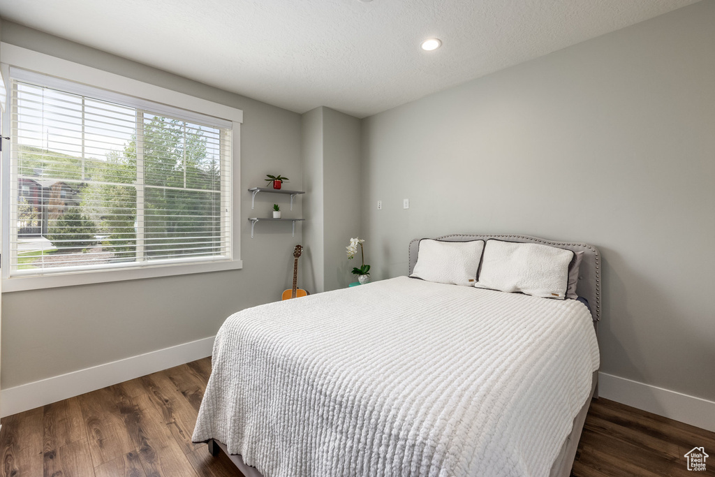 Bedroom with wood finished floors and recessed lighting
