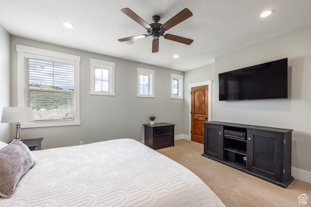 Bedroom featuring light colored carpet, recessed lighting, a textured ceiling, and a ceiling fan