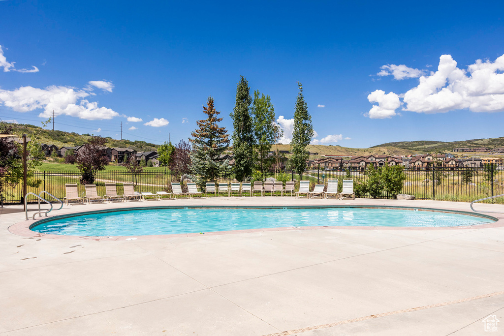Community pool with a patio