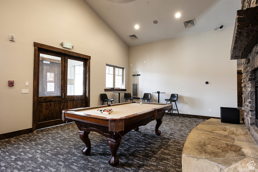 Recreation room with high vaulted ceiling, billiards, and carpet floors