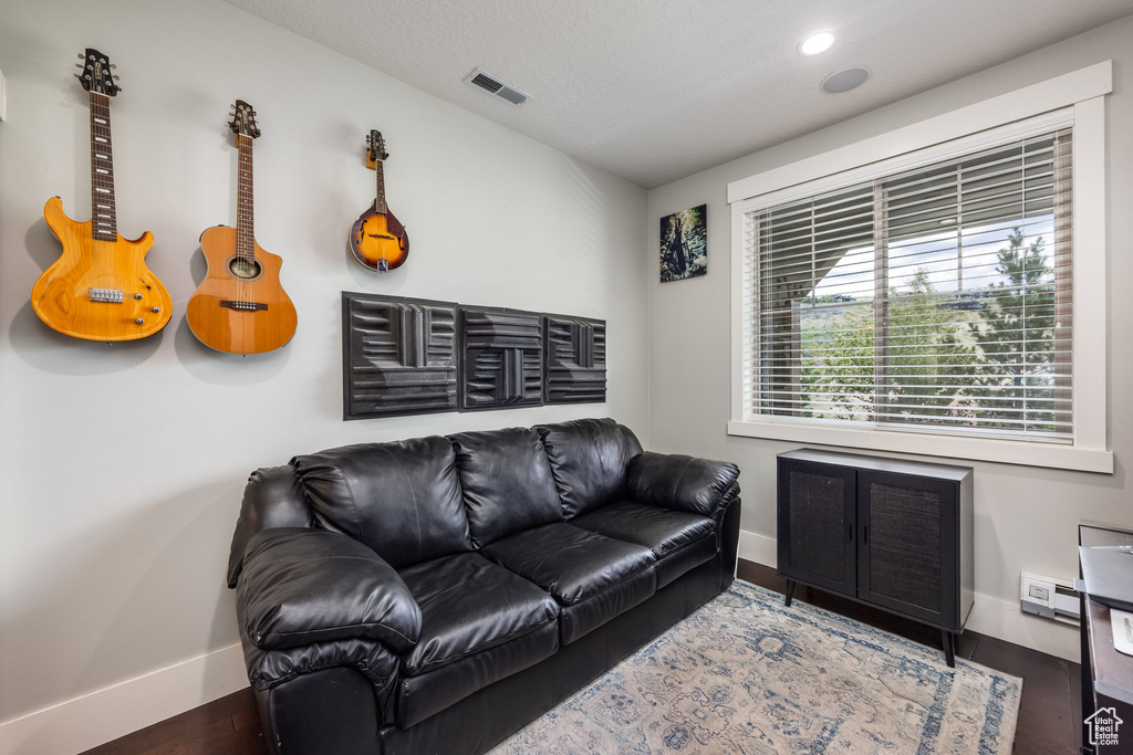 Living area with wood finished floors and recessed lighting