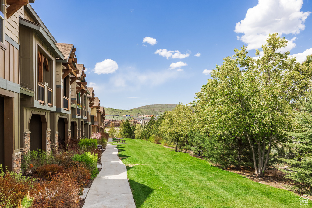View of green lawn featuring a residential view