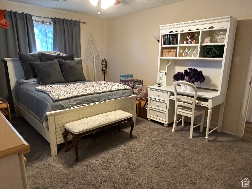 Bedroom featuring dark carpet