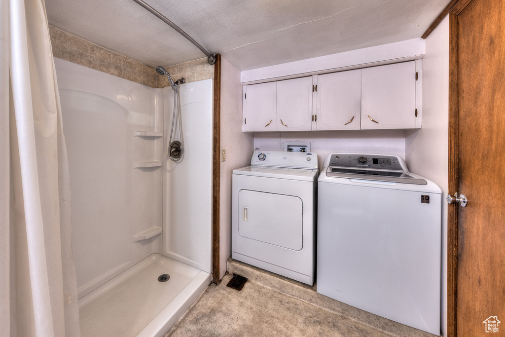 Washroom with laundry area and washing machine and clothes dryer