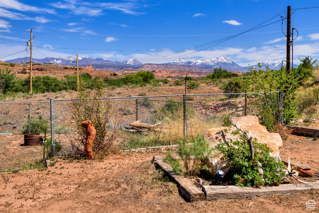View of yard with fence and a mountain view