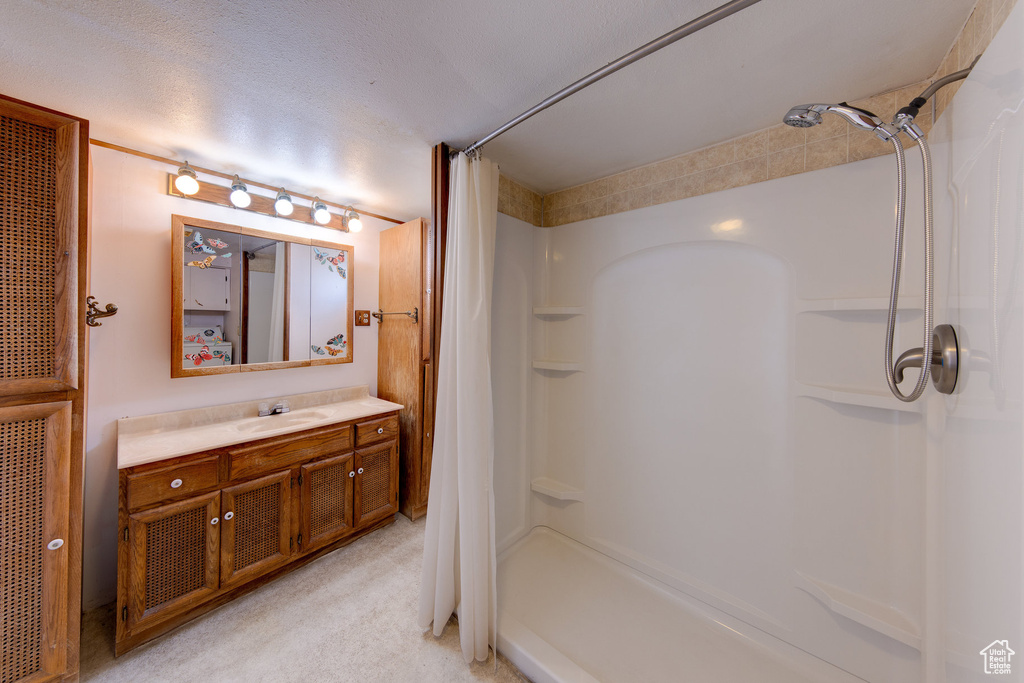 Bathroom featuring vanity and curtained shower