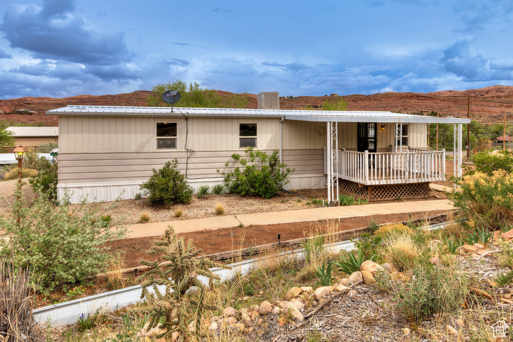 View of front of property featuring a deck with mountain view