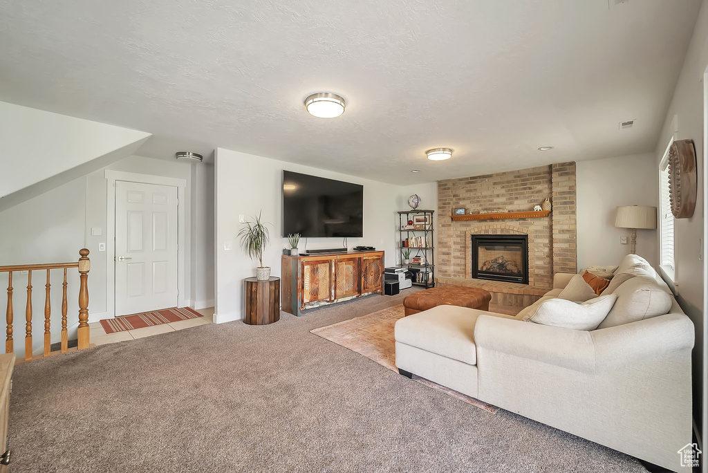 Carpeted living area with a fireplace