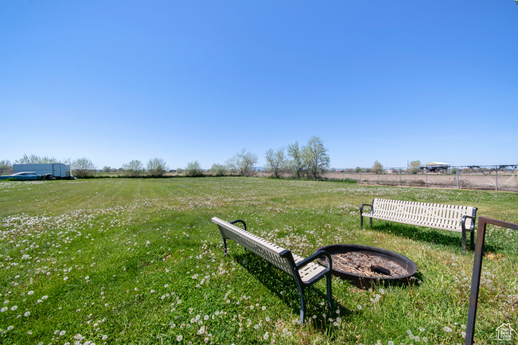 View of yard featuring fence and a rural view