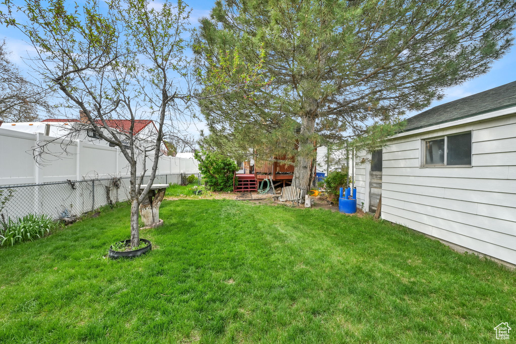View of yard featuring fence and a wooden deck