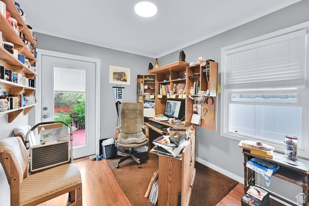 Home office with baseboards and wood finished floors