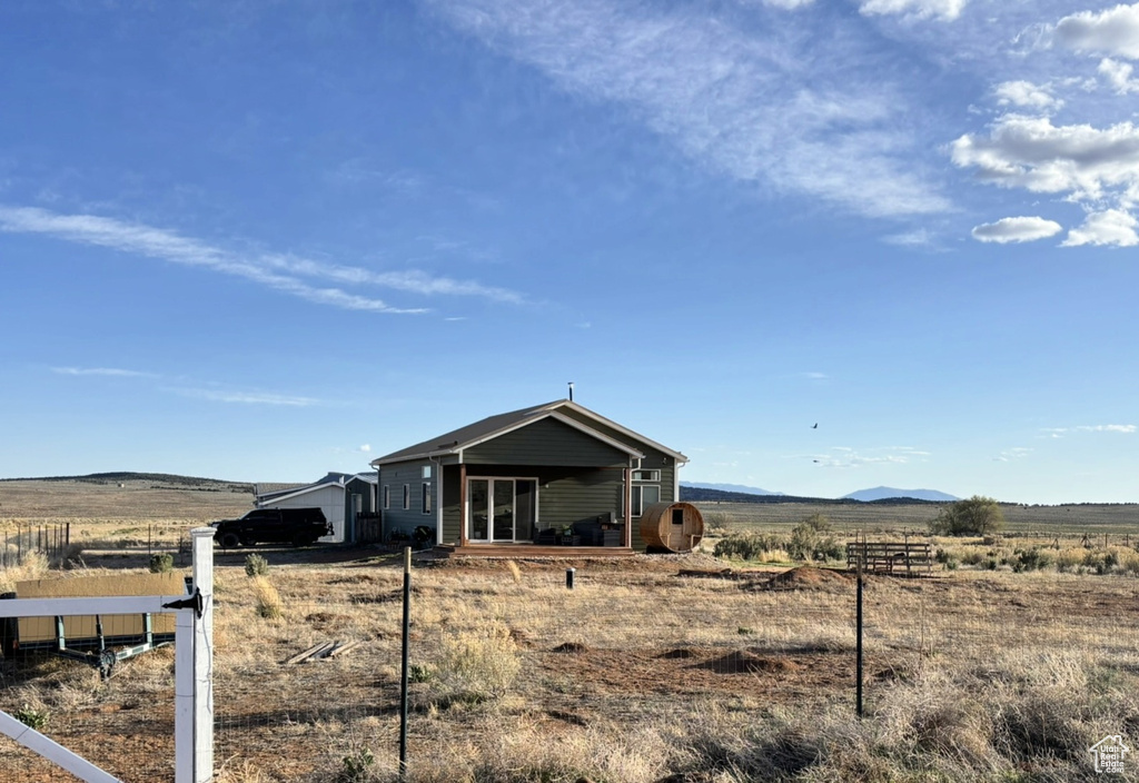 Exterior space featuring a rural view and fence