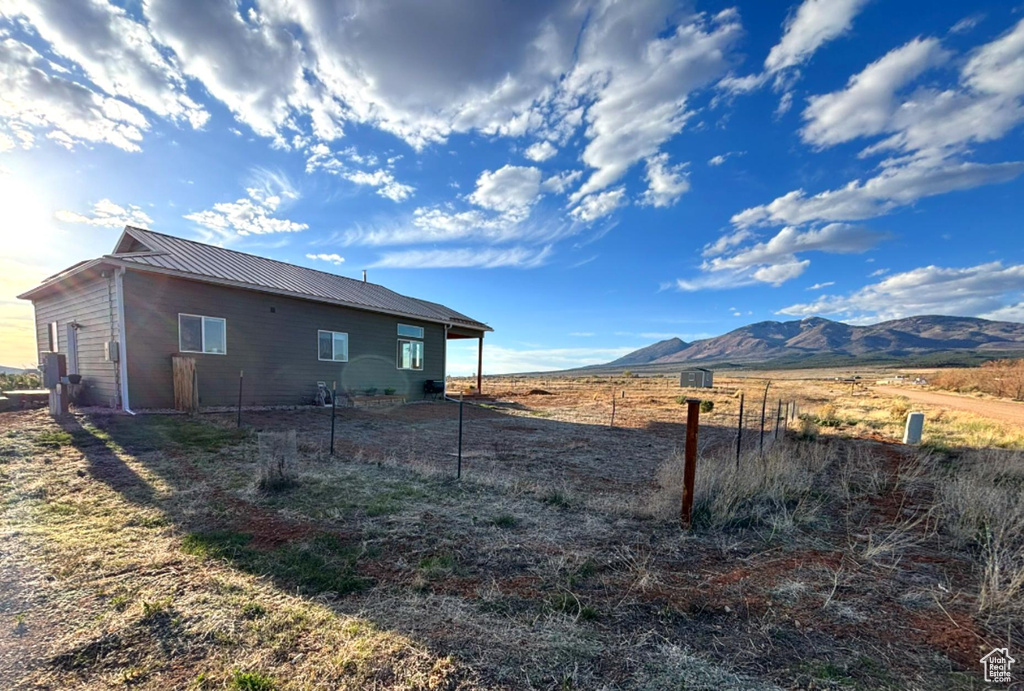 View of yard with fence and a mountain view
