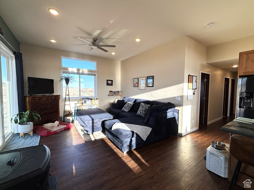 Living room featuring dark wood finished floors, recessed lighting, a ceiling fan, and baseboards
