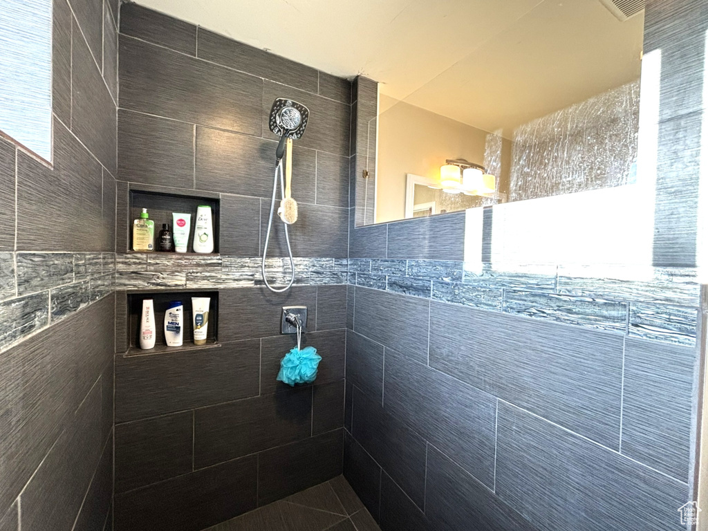 Full bath featuring a tile shower