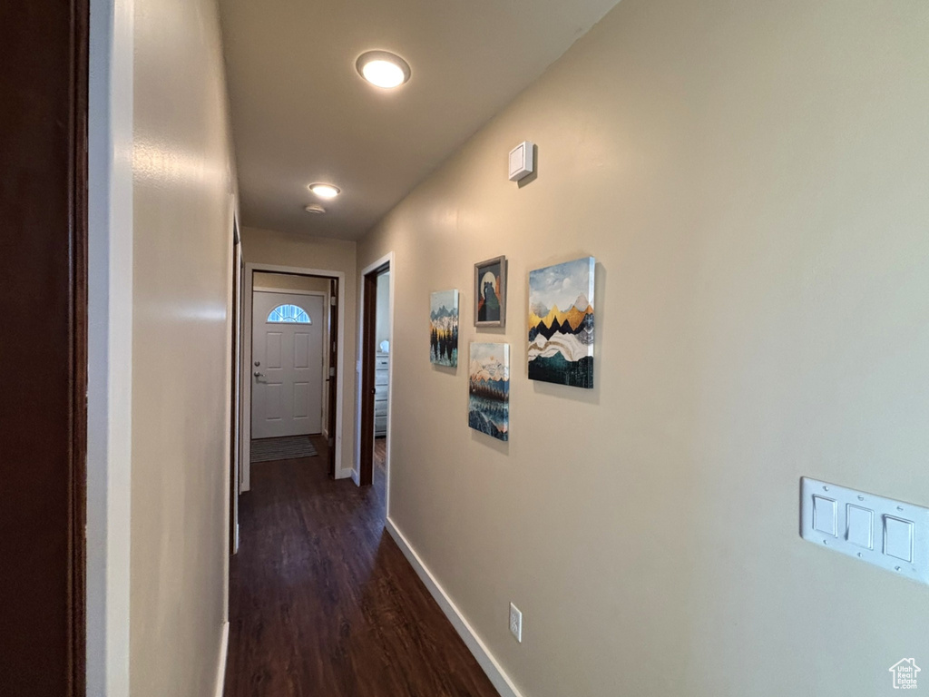 Hallway with recessed lighting, dark wood finished floors, and baseboards