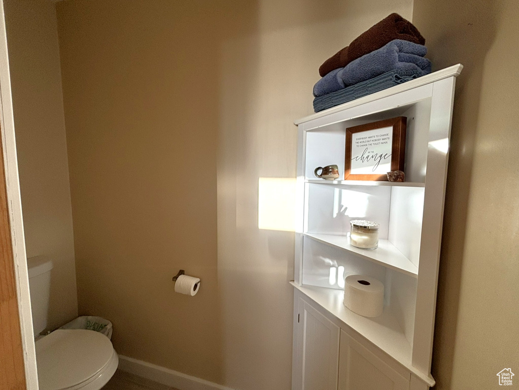 Bathroom with toilet and baseboards