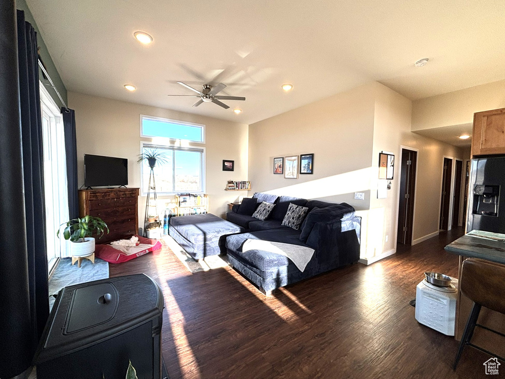 Bedroom with recessed lighting, refrigerator with ice dispenser, baseboards, and dark wood-type flooring