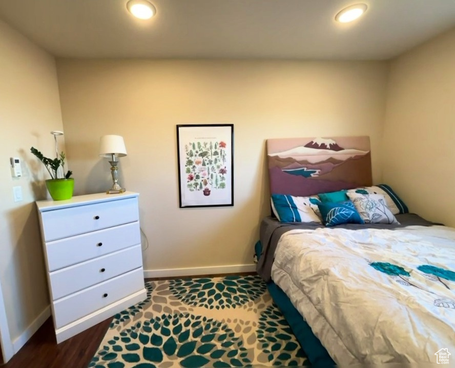 Bedroom featuring recessed lighting, dark wood-style flooring, and baseboards