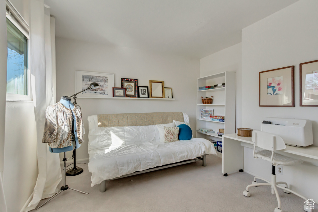 Carpeted bedroom featuring baseboards