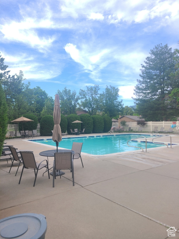 Community pool featuring a patio area