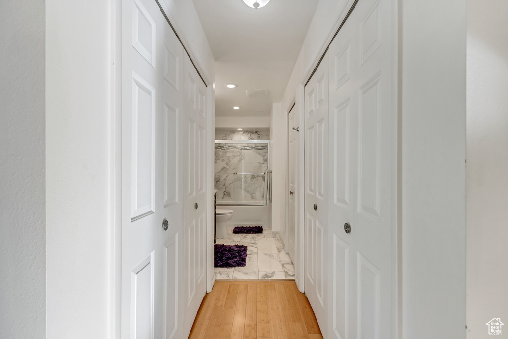 Hall featuring marble finish floor and recessed lighting