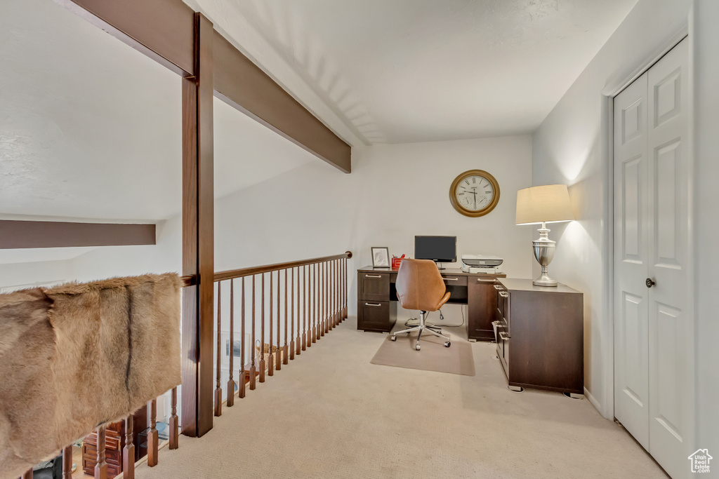Office area with lofted ceiling with beams and light carpet