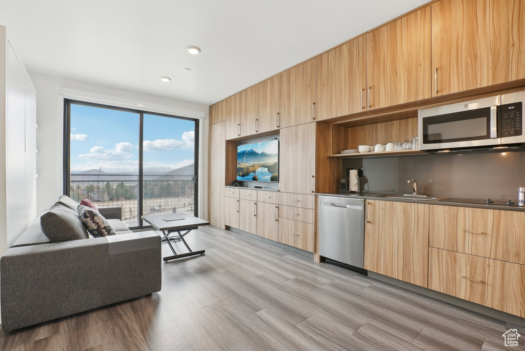 Living room featuring recessed lighting and light wood-style flooring