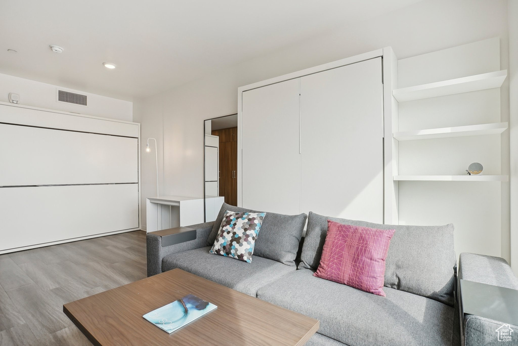 Living area featuring recessed lighting, visible vents, and wood finished floors