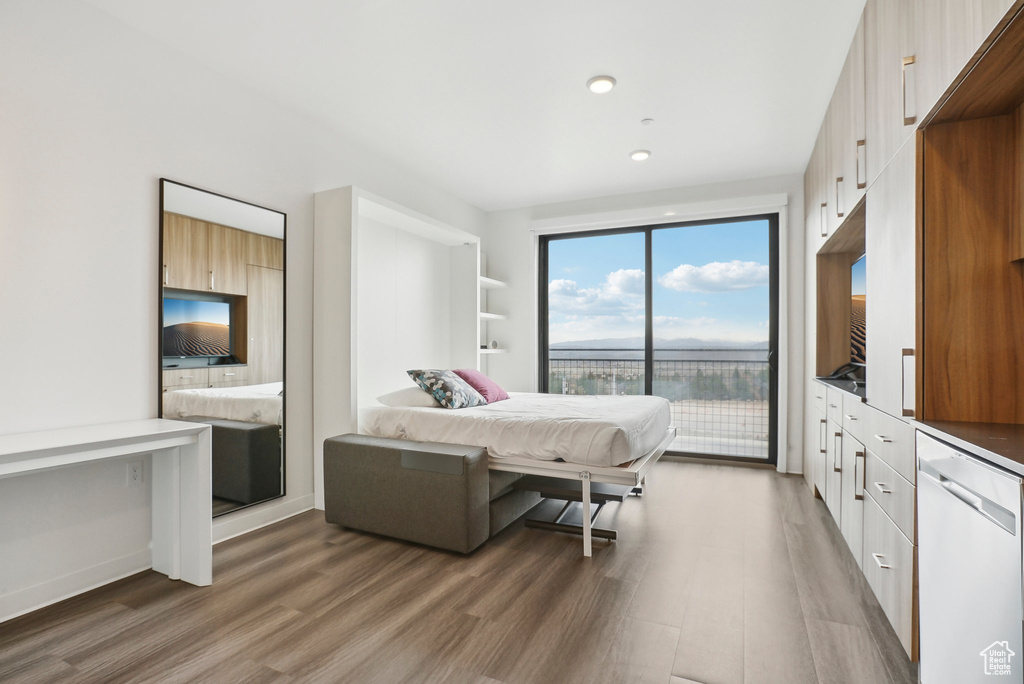Bedroom with light wood-type flooring, recessed lighting, and access to exterior