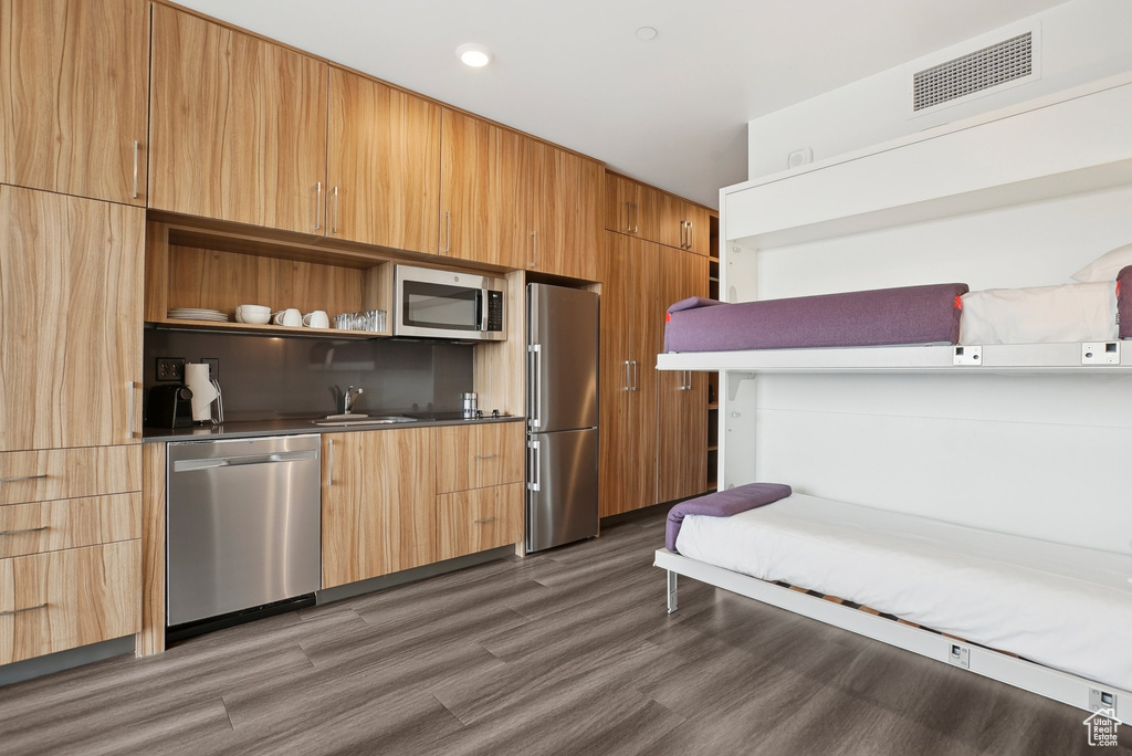 Kitchen featuring a sink, modern cabinets, stainless steel appliances, open shelves, and visible vents