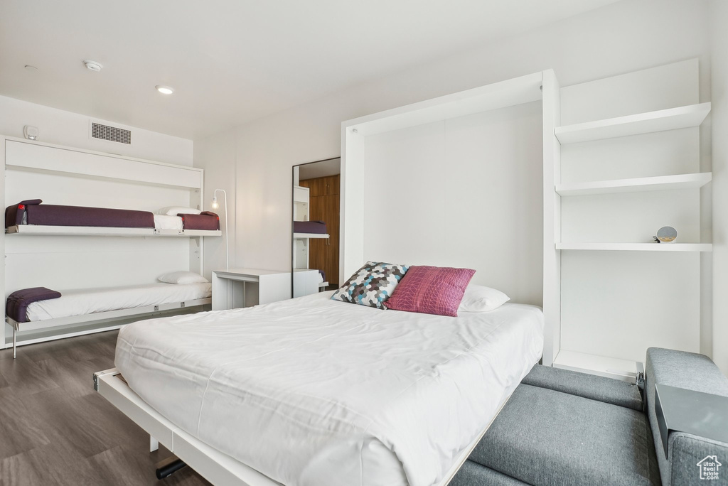 Bedroom with wood finished floors and visible vents