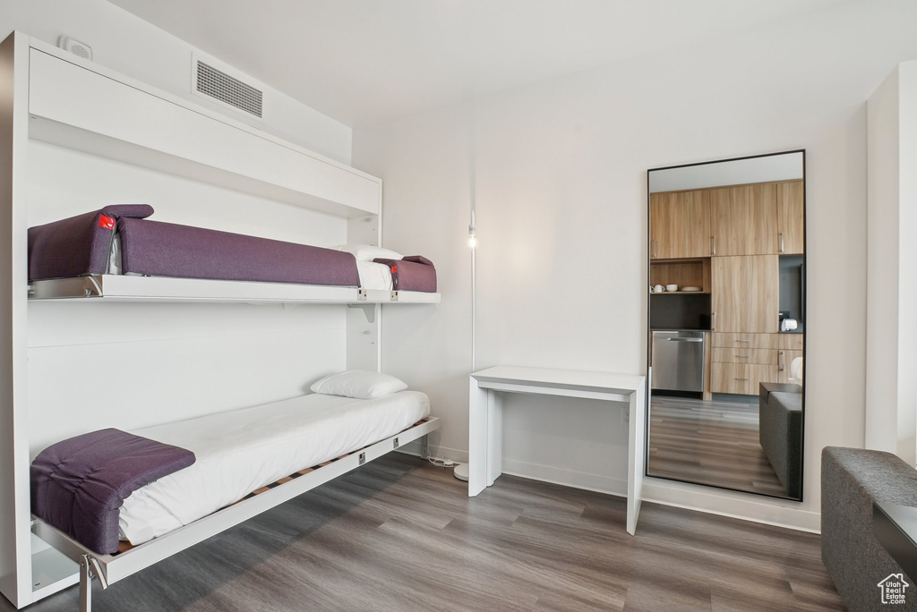 Bedroom with wood finished floors and visible vents