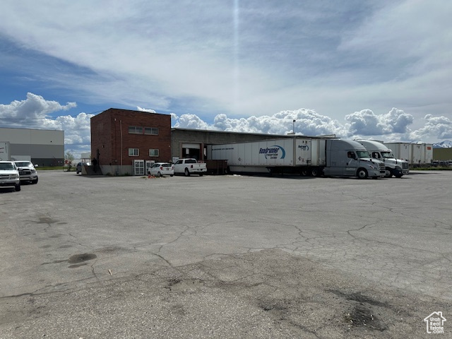 View of building exterior with uncovered parking