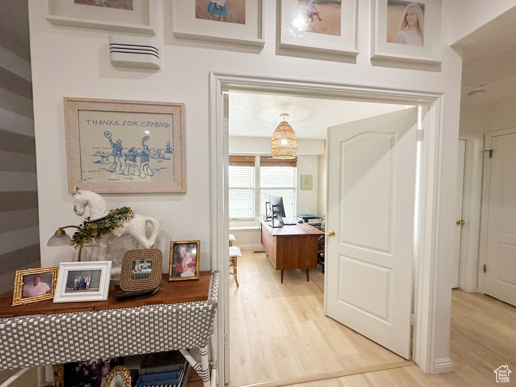 Corridor with light wood finished floors