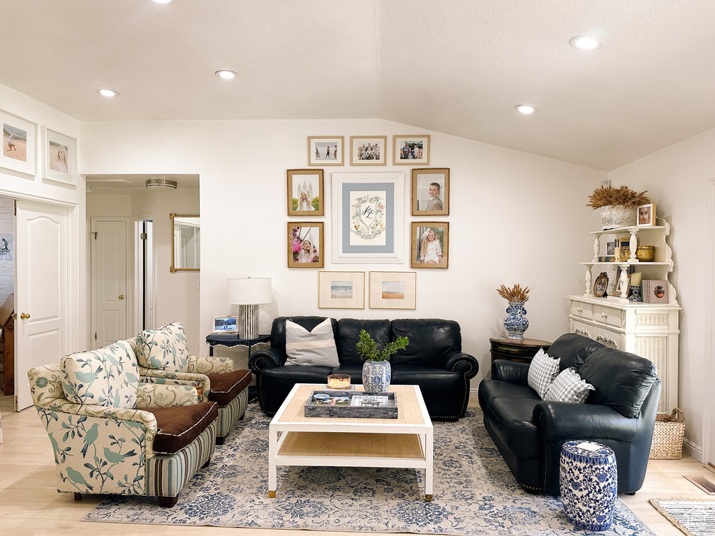 Living room with recessed lighting, vaulted ceiling, and light wood finished floors