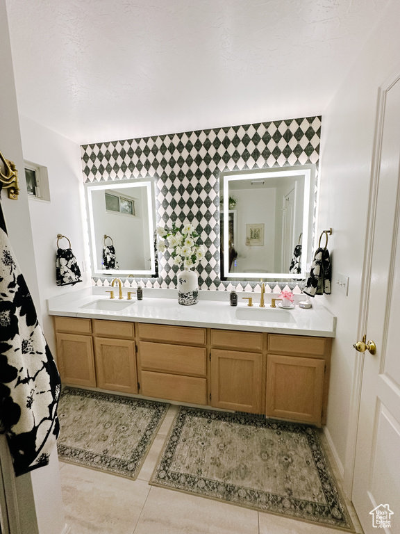 Full bathroom featuring double vanity and a sink