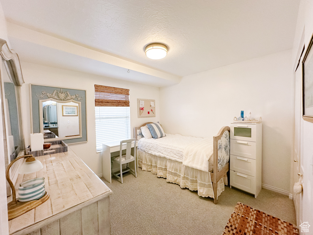 Bedroom with baseboards and carpet flooring