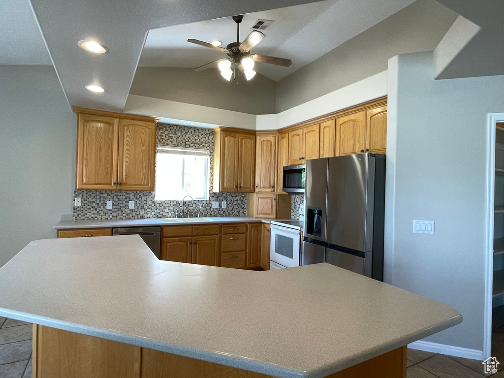 Kitchen featuring tasteful backsplash, appliances with stainless steel finishes, light countertops, ceiling fan, and visible vents