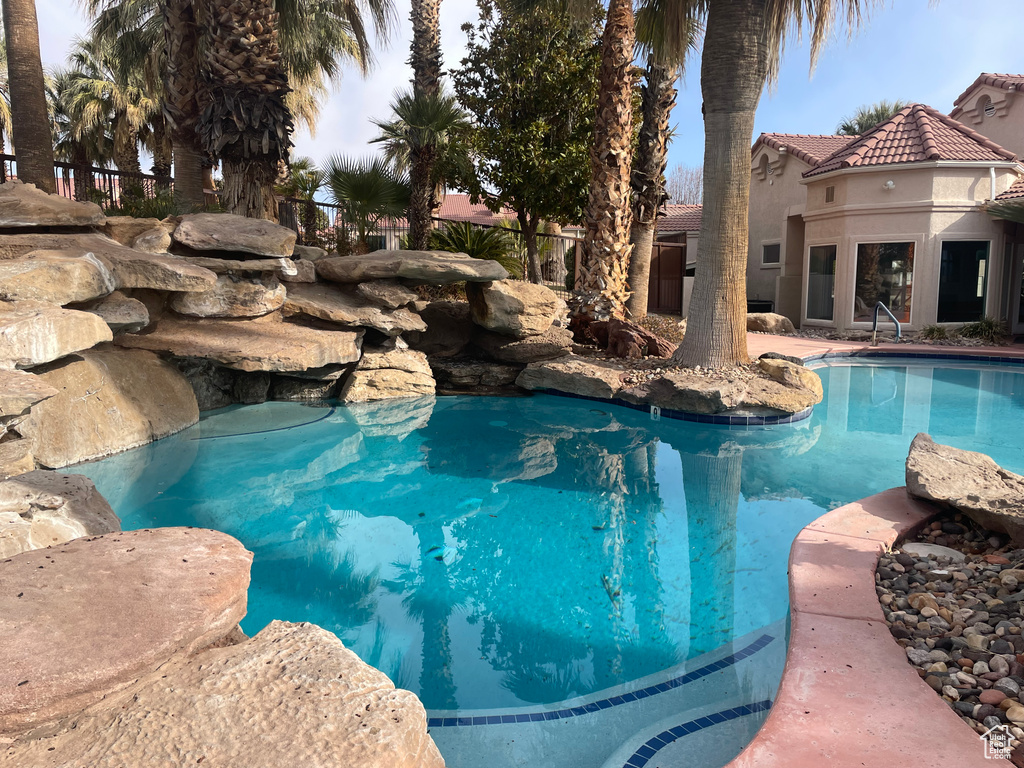 View of pool with fence and a fenced in pool