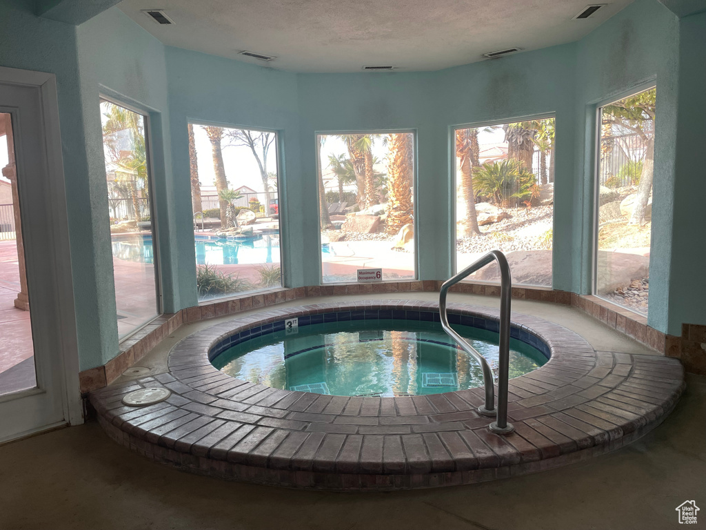 View of pool with an indoor hot tub