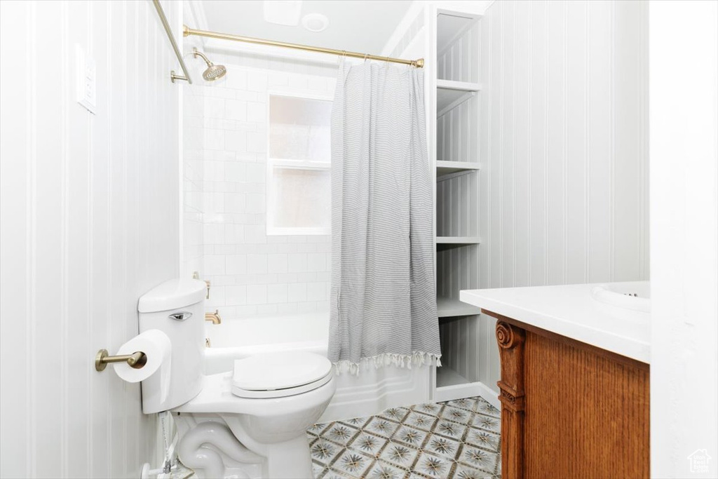 Full bathroom with vanity, shower / tub combo, and toilet